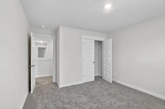 a view of an empty room and closet area