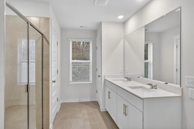 a bathroom with a sink double vanity and a mirror