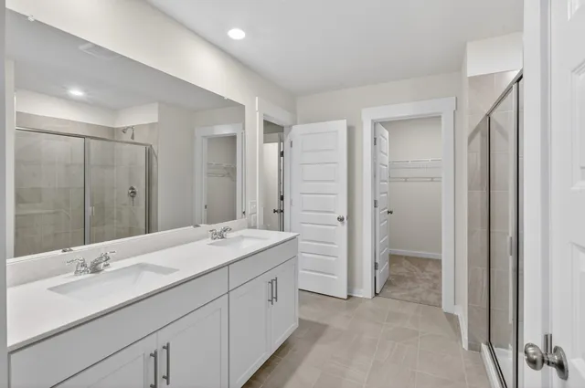 a spacious bathroom with a shower sink double and mirror
