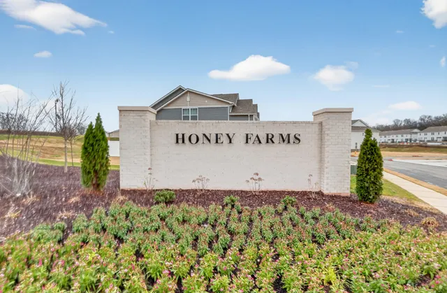 a sign of golf club on a wall under a umbrella