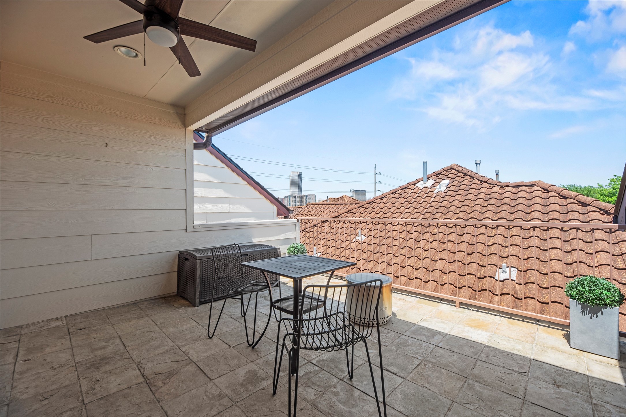 1537 Haddon Street Houston, TX 77006 - Photo 30 of 48 The covered patio with tile flooring, featuring a ceiling fan and outdoor seating. The space offers offers privacy and is perfect for relaxing or entertaining.