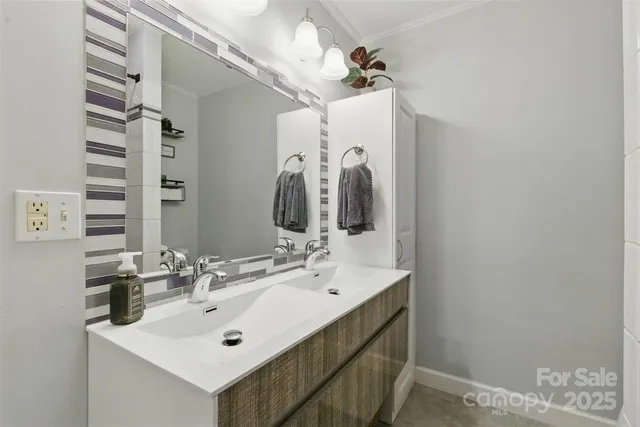 a bathroom with a sink vanity and a mirror