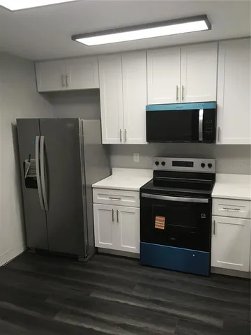 a kitchen with a refrigerator stove and microwave