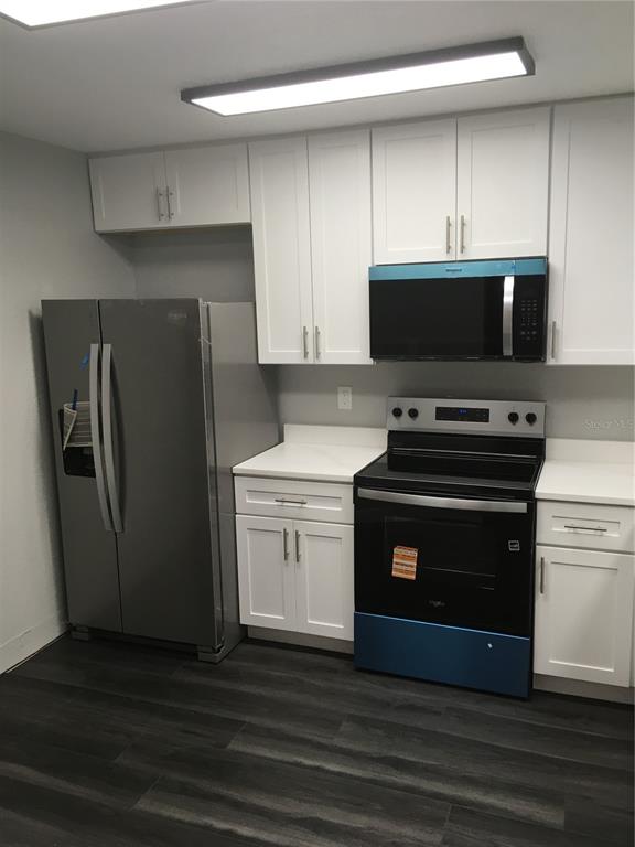 a kitchen with a refrigerator stove and microwave