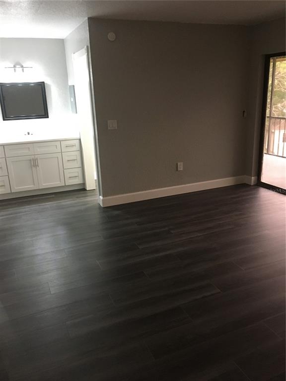 630 Cranes Way, Unit 307 Altamonte Springs, FL 32701 - Photo 7 of 8 an empty room with wooden floor and windows