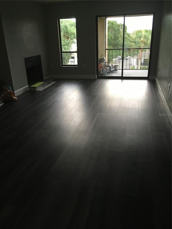 630 Cranes Way, Unit 307 Altamonte Springs, FL 32701 - Photo 8 of 8 an empty room with wooden floor and windows