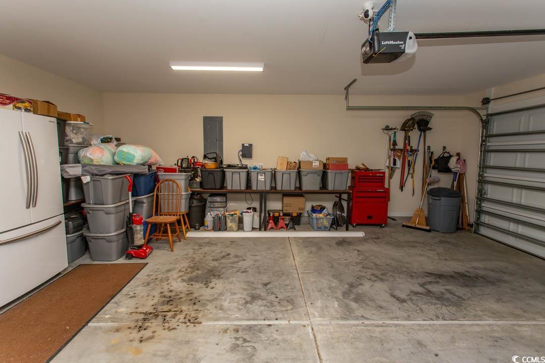 125 St Barnabus Road Loris, SC 29569 - Photo 37 of 39 Garage featuring electric panel, a garage door ope