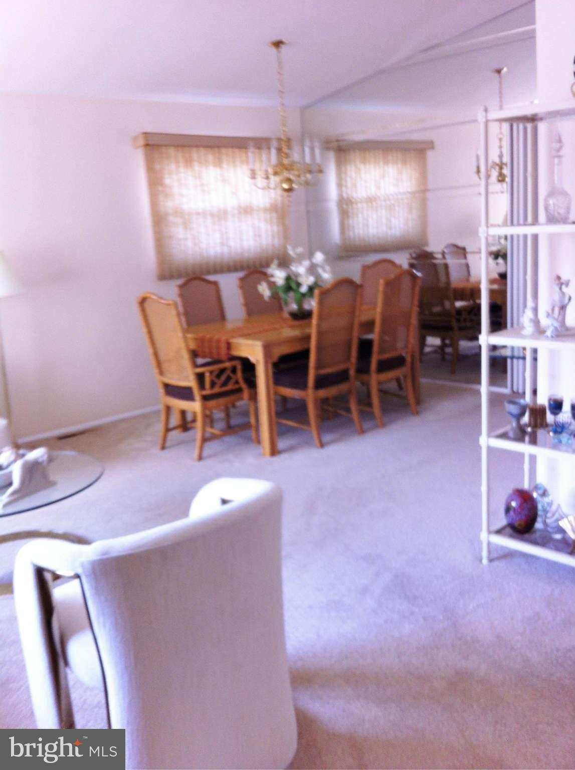 3900 Setonhurst Road Baltimore, MD 21208 - Photo 18 of 20 a view of a dining room with furniture and chandelier