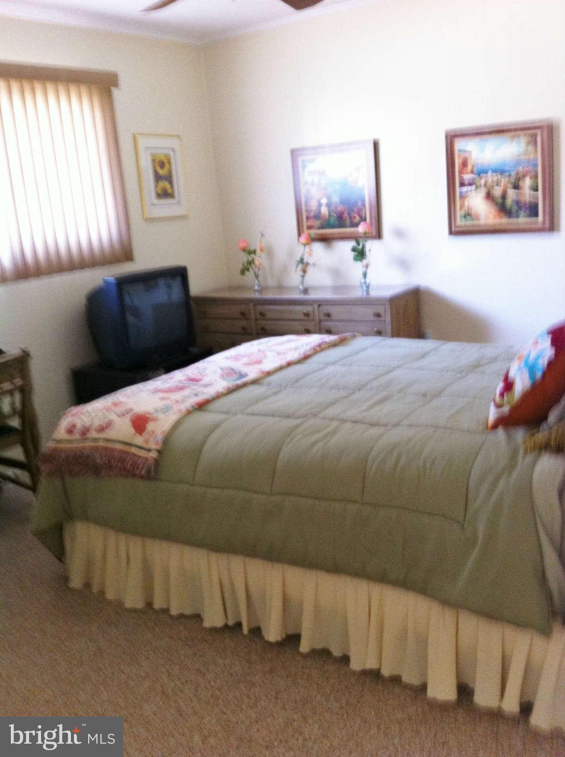 3900 Setonhurst Road Baltimore, MD 21208 - Photo 5 of 20 a bedroom with a bed and a painting on the wall