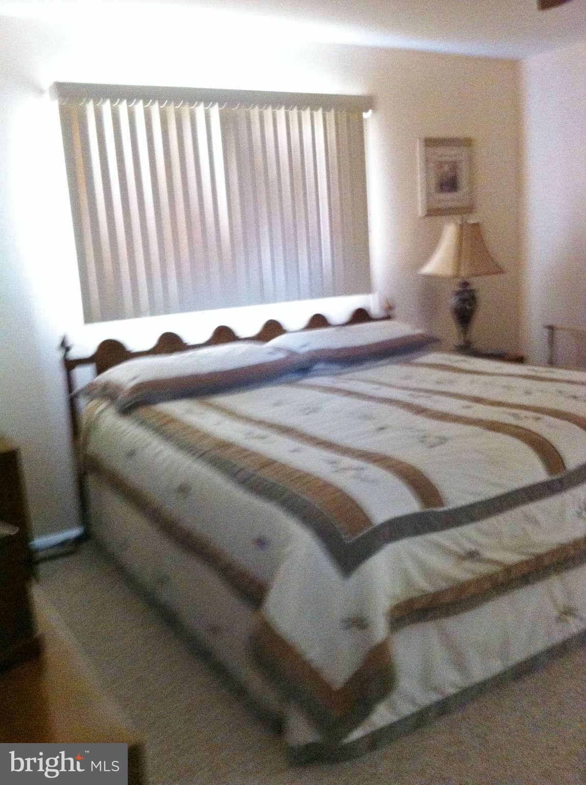 3900 Setonhurst Road Baltimore, MD 21208 - Photo 6 of 20 a bed sitting in a bedroom next to a window