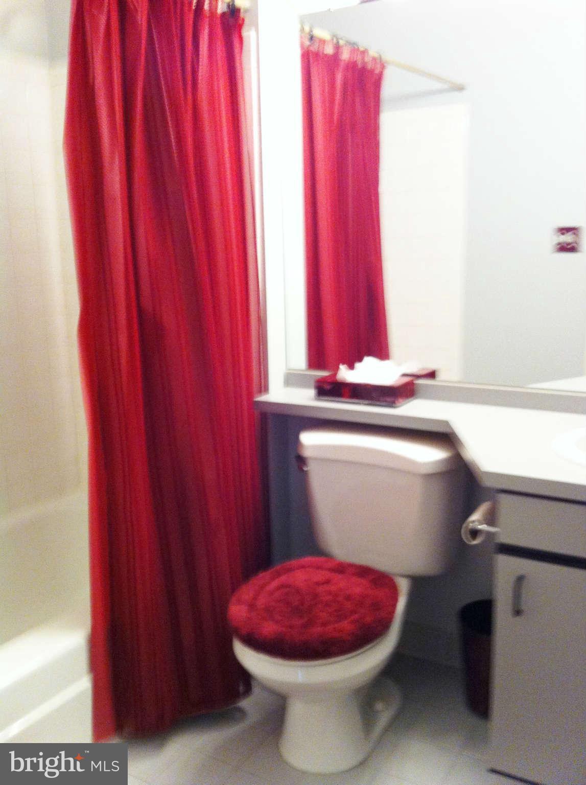 3900 Setonhurst Road Baltimore, MD 21208 - Photo 8 of 20 a bathroom with a sink toilet and shower