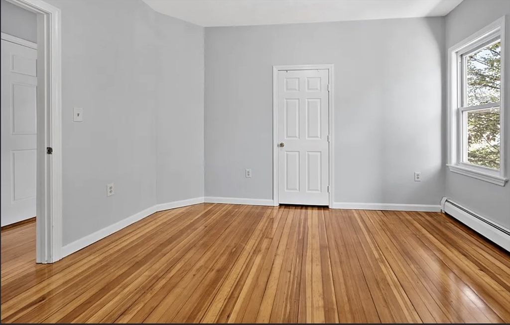61 Shurtleff Street, Unit 4 Chelsea, MA 02150 - Photo 13 of 22 a view of an empty room with wooden floor and a window