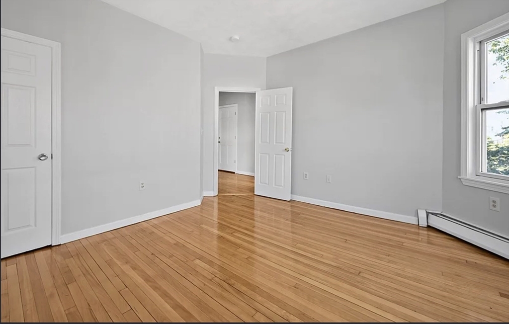 61 Shurtleff Street, Unit 4 Chelsea, MA 02150 - Photo 15 of 22 a view of an empty room with wooden floor and a window