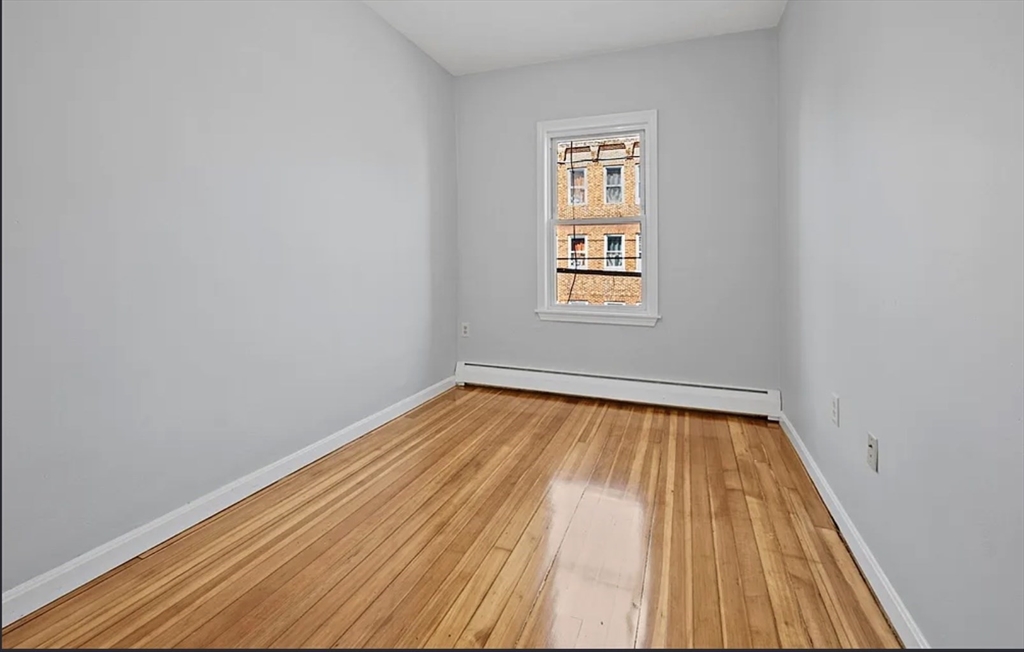 61 Shurtleff Street, Unit 4 Chelsea, MA 02150 - Photo 18 of 22 a view of a room with wooden floor and window