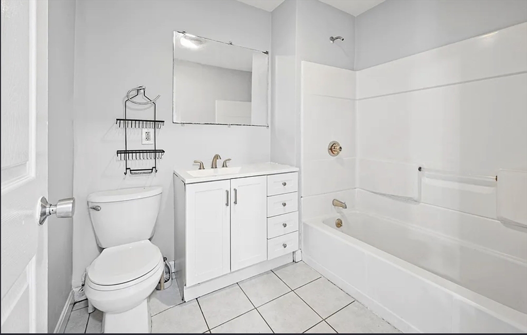 61 Shurtleff Street, Unit 4 Chelsea, MA 02150 - Photo 20 of 22 a bathroom with a sink toilet and bathtub