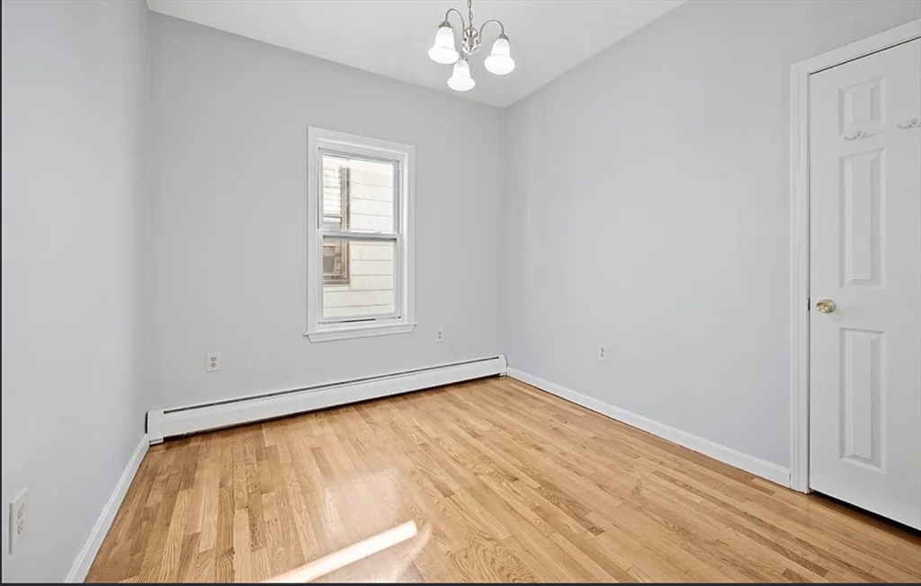61 Shurtleff Street, Unit 4 Chelsea, MA 02150 - Photo 22 of 22 wooden floor in an empty room with a window
