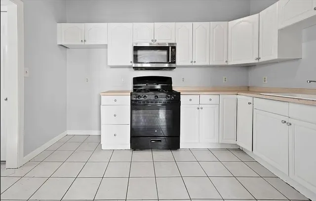 a kitchen with cabinets and appliances