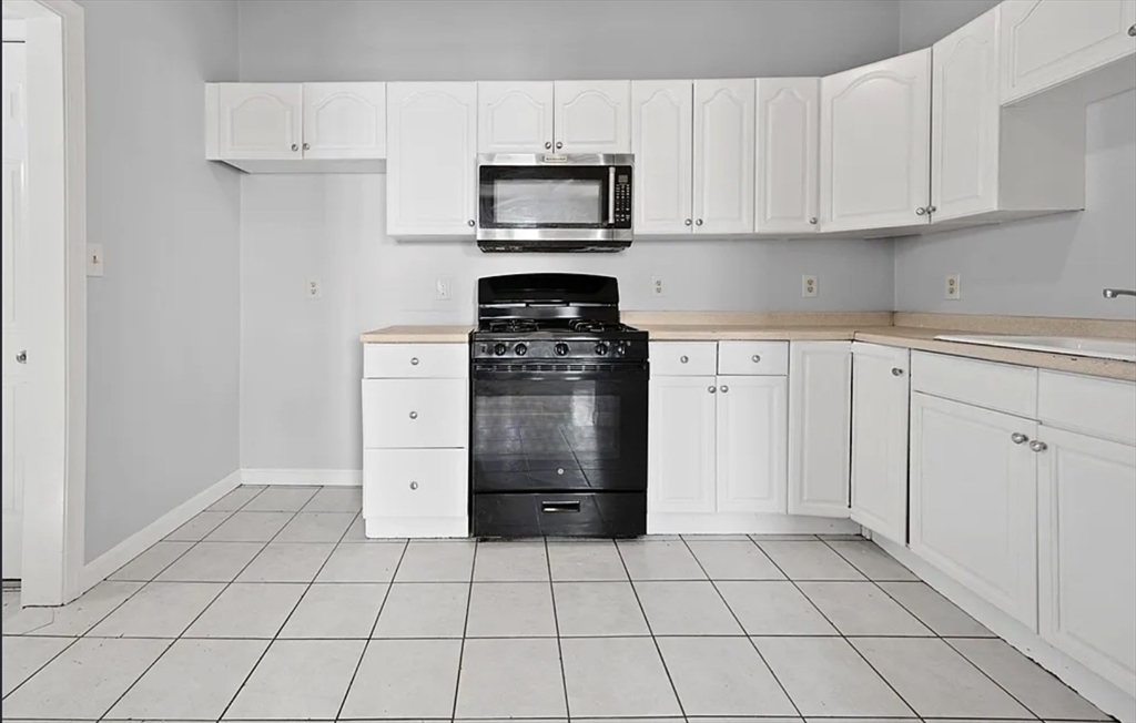 61 Shurtleff Street, Unit 4 Chelsea, MA 02150 - Photo 3 of 22 a kitchen with cabinets and appliances