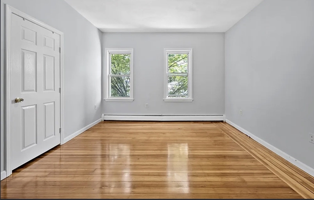 61 Shurtleff Street, Unit 4 Chelsea, MA 02150 - Photo 10 of 22 a view of an empty room with wooden floor and window