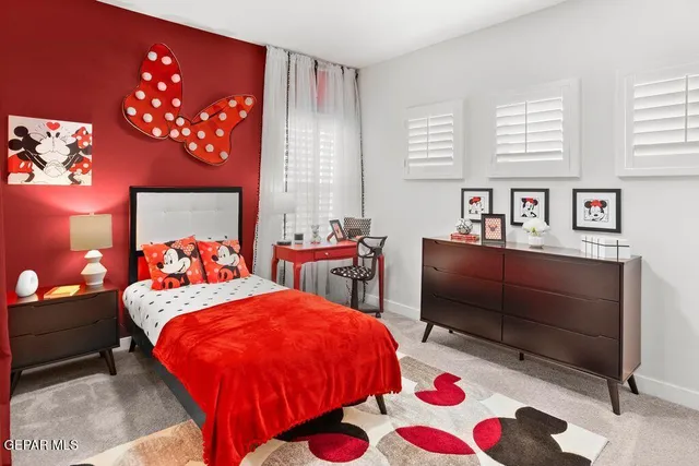 a bed room with a bed and a chair