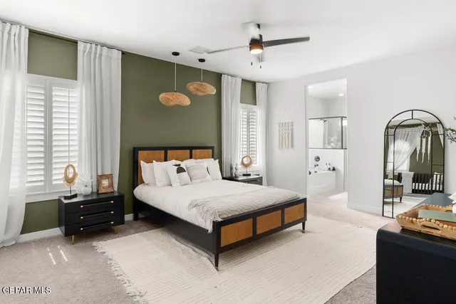 a bedroom with a bed next to a window with a flat screen tv