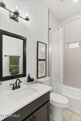 a bathroom with a sink a toilet and mirror