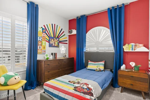 a bedroom with a bed and a dresser