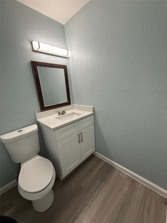 313 Rolston Road, Unit 301103 Irving, TX 75060 - Photo 3 of 15 a white toilet sitting next to a bathroom sink
