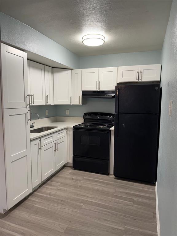 313 Rolston Road, Unit 301103 Irving, TX 75060 - Photo 4 of 15 a kitchen with a refrigerator and a stove top oven