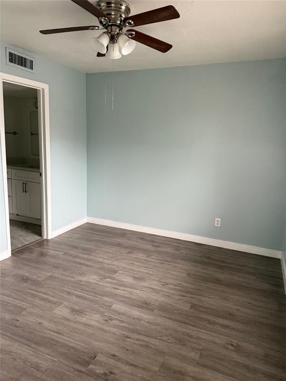 313 Rolston Road, Unit 301103 Irving, TX 75060 - Photo 6 of 15 a view of an empty room with wooden floor