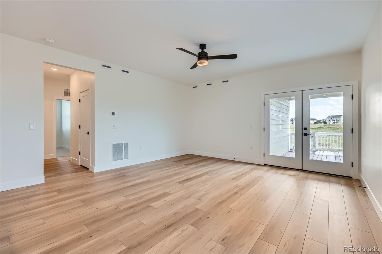 42982 Colonial Trail Elizabeth, CO 80107 - Photo 14 of 31 wooden floor in an empty room with a window