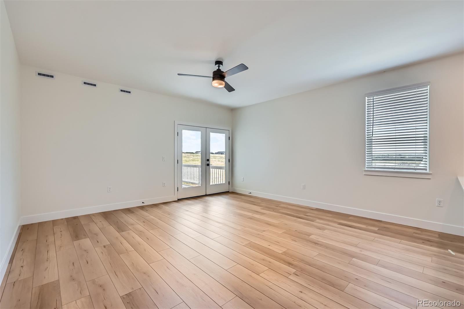 42982 Colonial Trail Elizabeth, CO 80107 - Photo 15 of 31 a view of an empty room with wooden floor and a window
