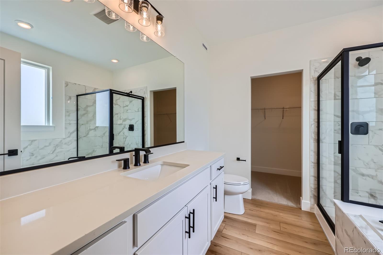 42982 Colonial Trail Elizabeth, CO 80107 - Photo 19 of 31 a bathroom with a double vanity sink toilet and shower