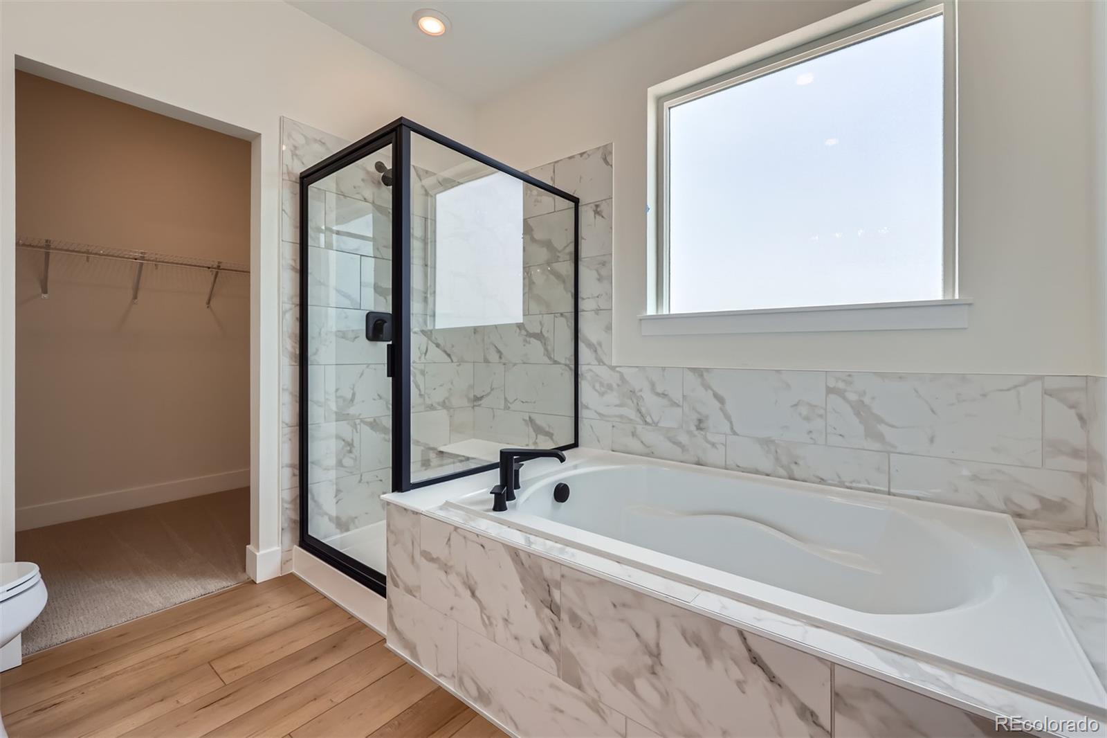 42982 Colonial Trail Elizabeth, CO 80107 - Photo 20 of 31 a bathroom with a bathtub and a shower
