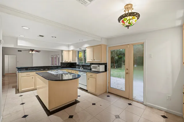 a kitchen with a stove a refrigerator and a sink