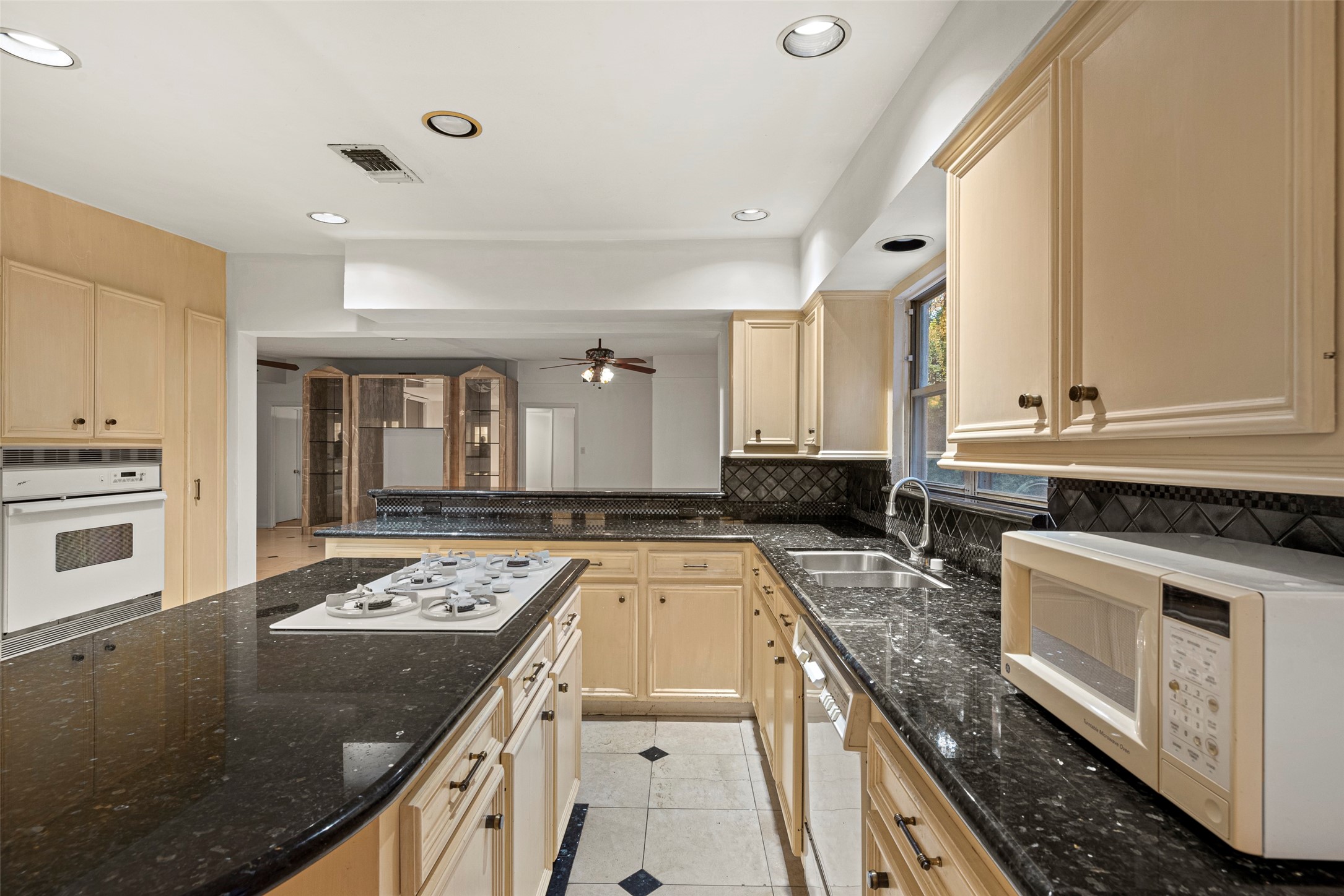 2927 Rockyridge Drive Houston, TX 77063 - Photo 12 of 34 a kitchen with a stove sink and cabinets