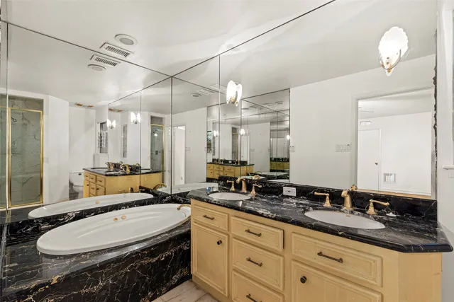 a bathroom with a double vanity sink and a mirror