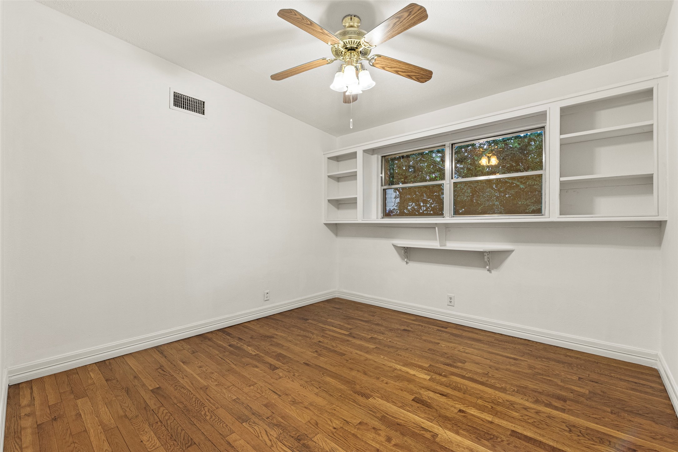 2927 Rockyridge Drive Houston, TX 77063 - Photo 20 of 34 an empty room with a window and a fan