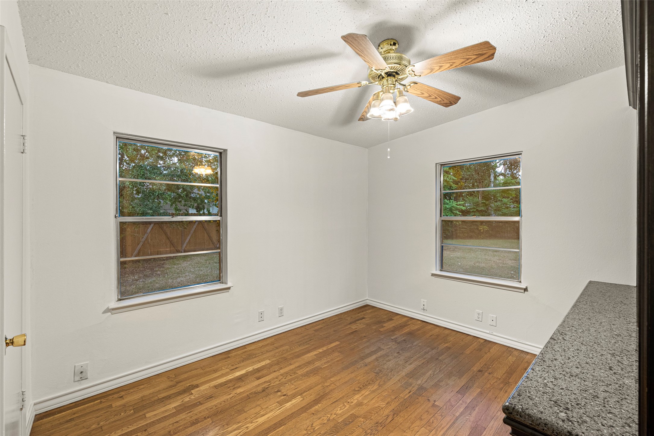 2927 Rockyridge Drive Houston, TX 77063 - Photo 21 of 34 a view of an empty room with wooden floor and a window