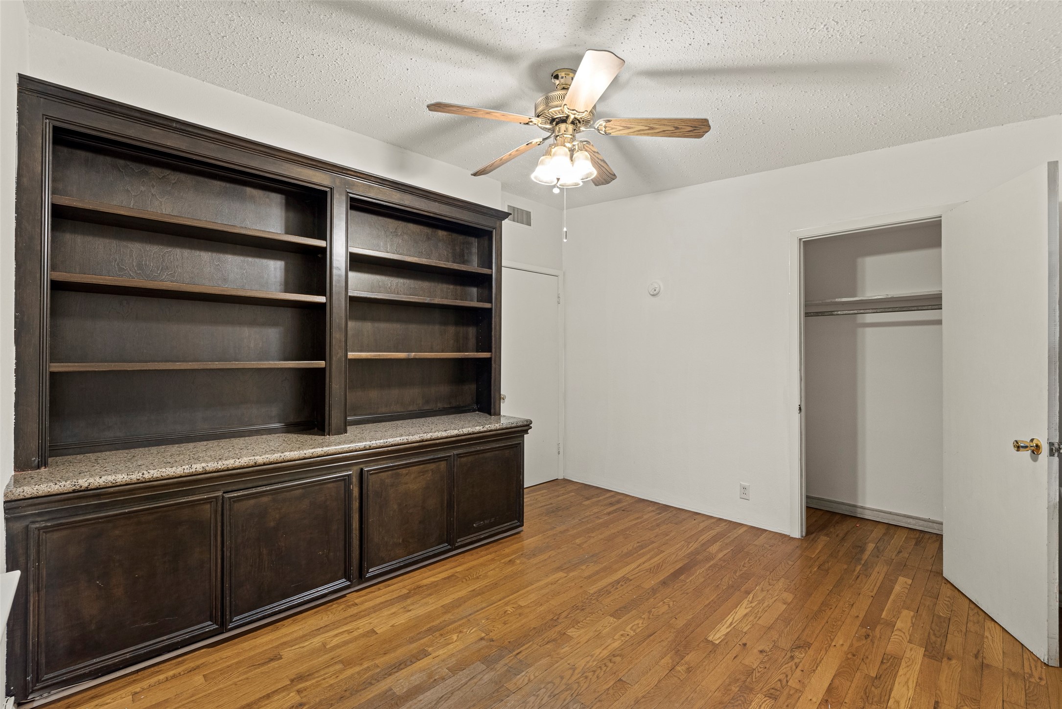 2927 Rockyridge Drive Houston, TX 77063 - Photo 22 of 34 a view of an empty room with a window and wooden floor
