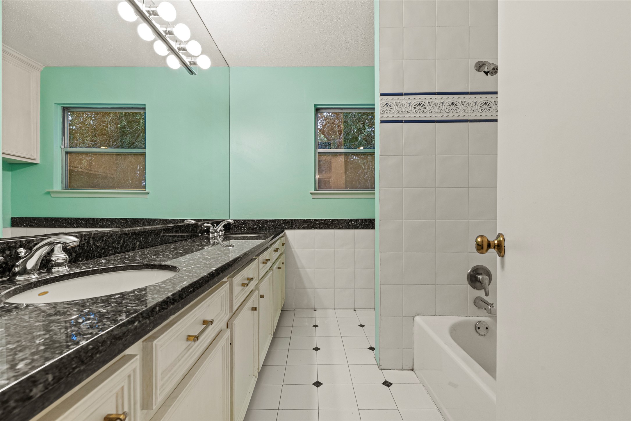 2927 Rockyridge Drive Houston, TX 77063 - Photo 24 of 34 a bathroom with a granite countertop sink mirror and bathtub