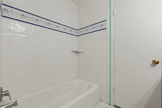 a bathroom with a shower and a bath tub