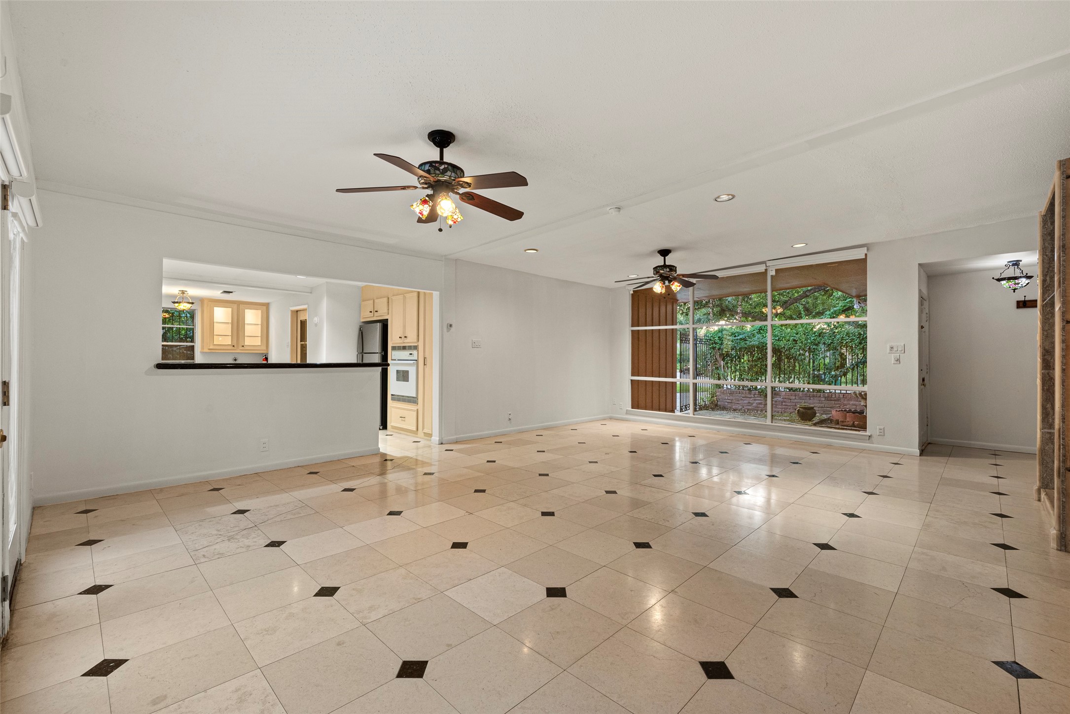 2927 Rockyridge Drive Houston, TX 77063 - Photo 7 of 34 a view of a livingroom with wooden floor and a ceiling fan