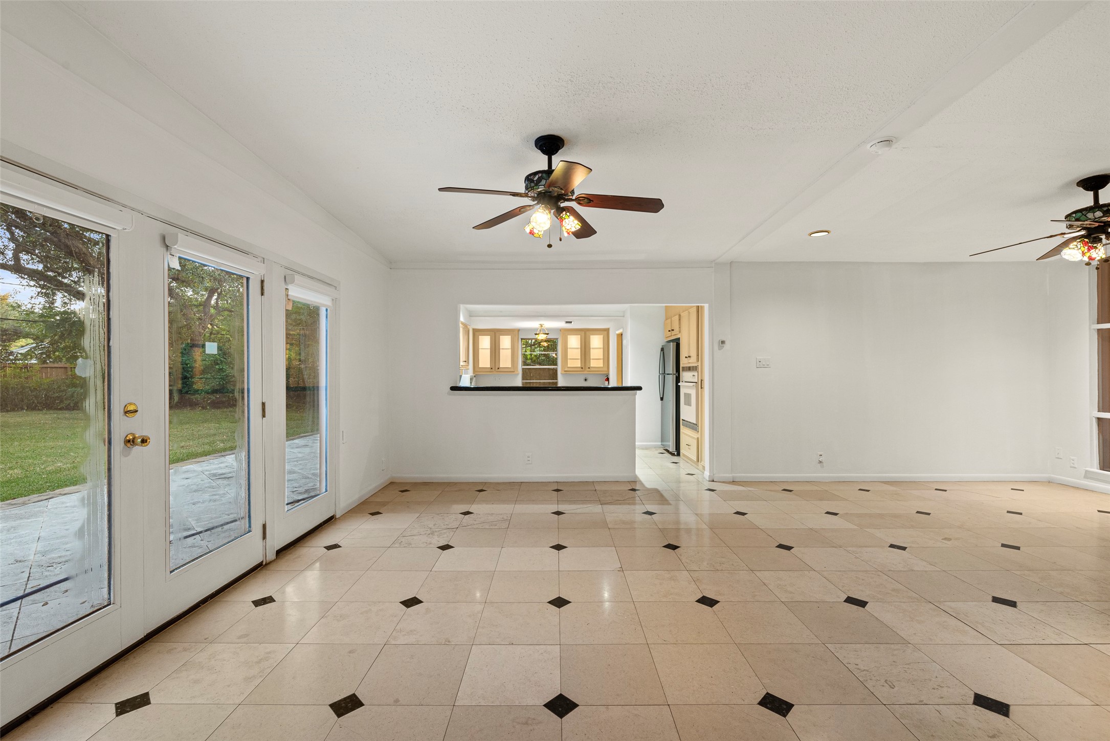 2927 Rockyridge Drive Houston, TX 77063 - Photo 9 of 34 a view of a hallway with a chandelier fan and windows