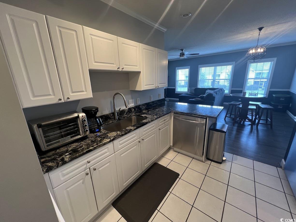 3965 Forsythia Court, Unit 202 Myrtle Beach, SC 29588 - Photo 3 of 15 Kitchen featuring stainless steel dishwasher, white cabinetry, a peninsula, a ceiling fan, and healthy amount of natural light