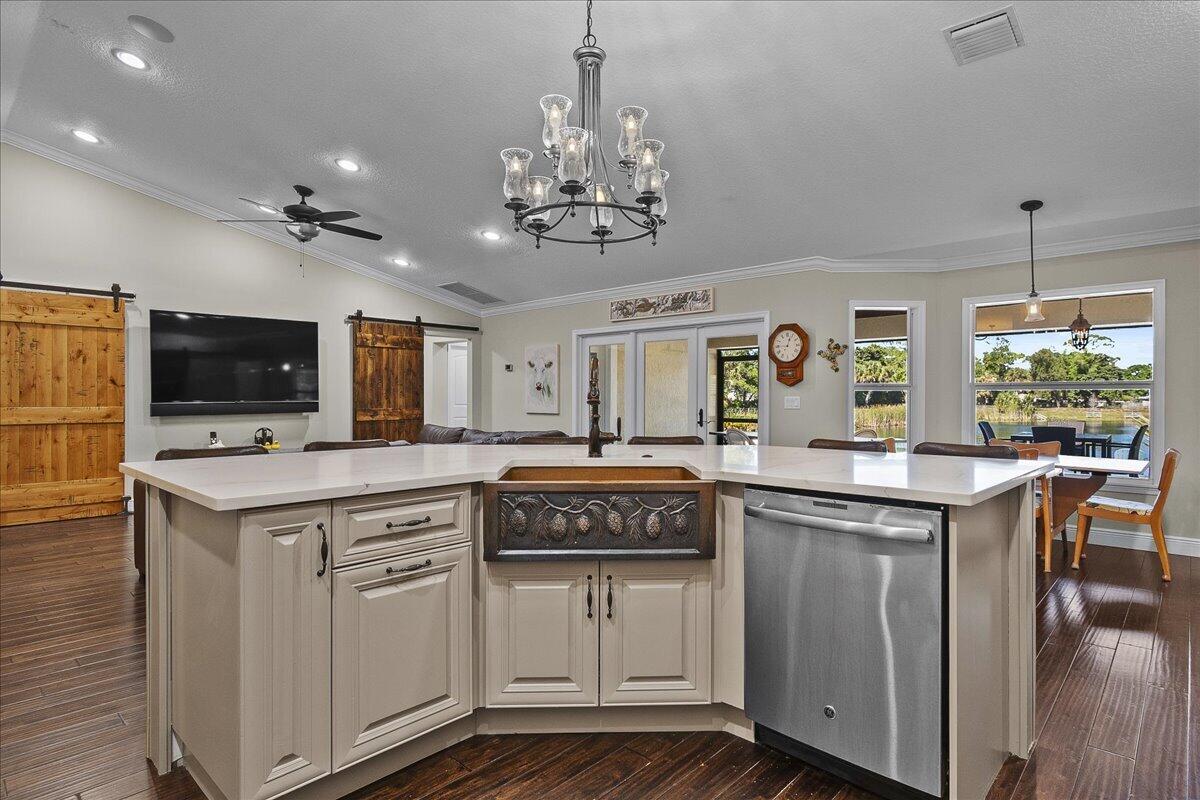 10975 Randolph Siding Road Jupiter, FL 33478 - Photo 24 of 97 a kitchen with kitchen island granite countertop stainless steel appliances a stove and a center island