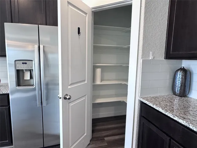 a bathroom with a granite countertop sink a mirror and shower