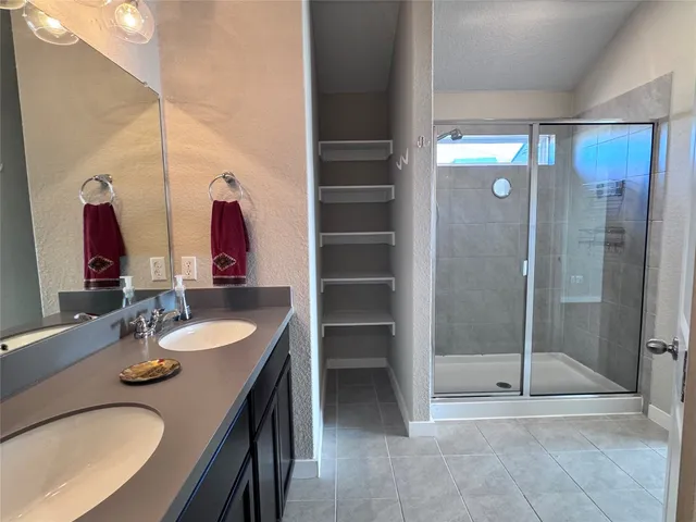 a bathroom with a double vanity sink and a mirror