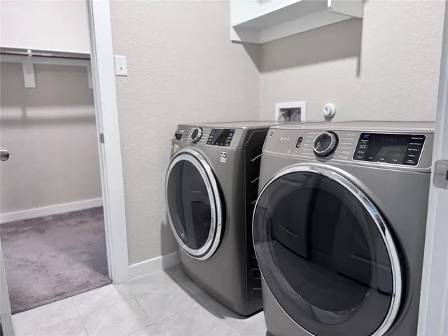a view of a hallway with wooden floor and stairs