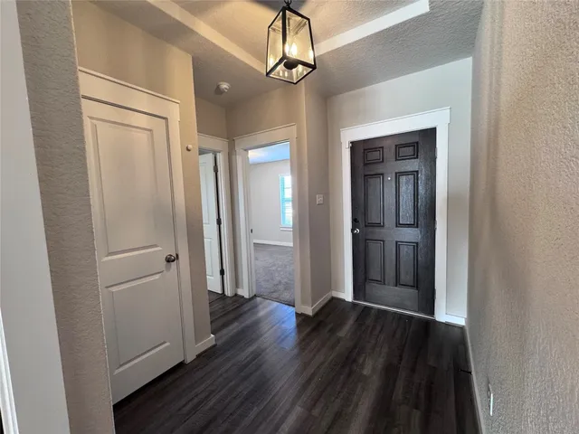 a large house with a big yard and large trees